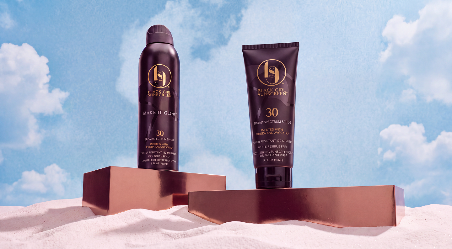 Black Girl Sunscreen spray and lotion packaging on display blocks